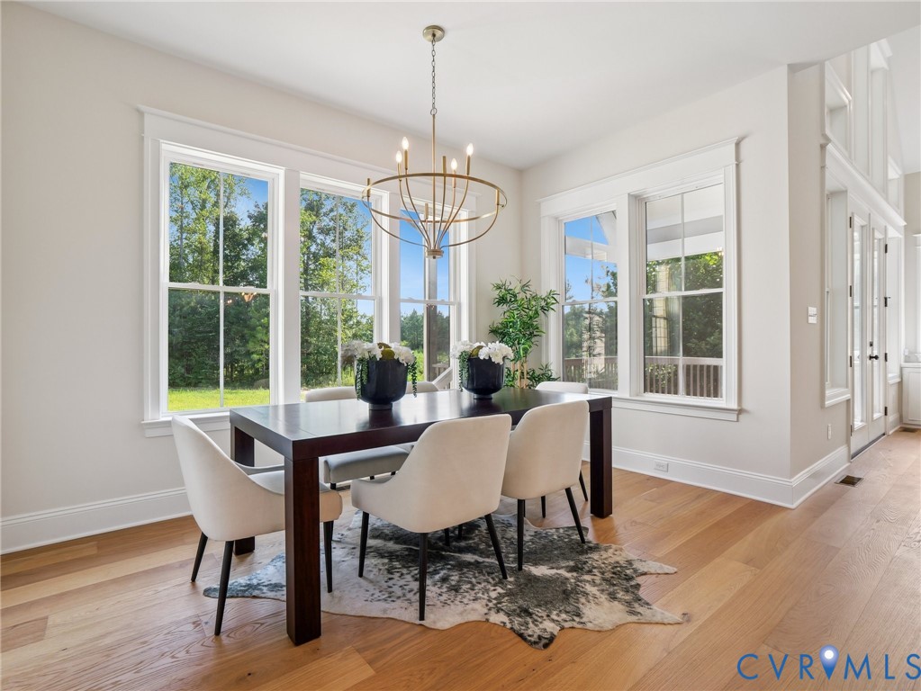 1530 Smokey Rdg Road Maidens, VA 23102 - Photo 11 of 42 a dining room with furniture a chandelier and wooden floor