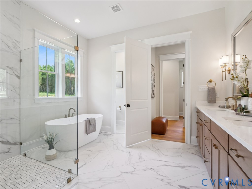 1530 Smokey Rdg Road Maidens, VA 23102 - Photo 23 of 42 a spacious bathroom with a double vanity sink a mirror a bathtub and a shower