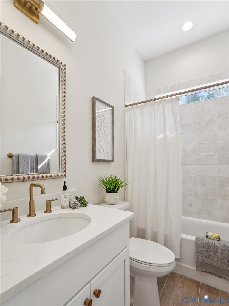1530 Smokey Rdg Road Maidens, VA 23102 - Photo 26 of 42 a bathroom with a sink a mirror a toilet and shower curtain