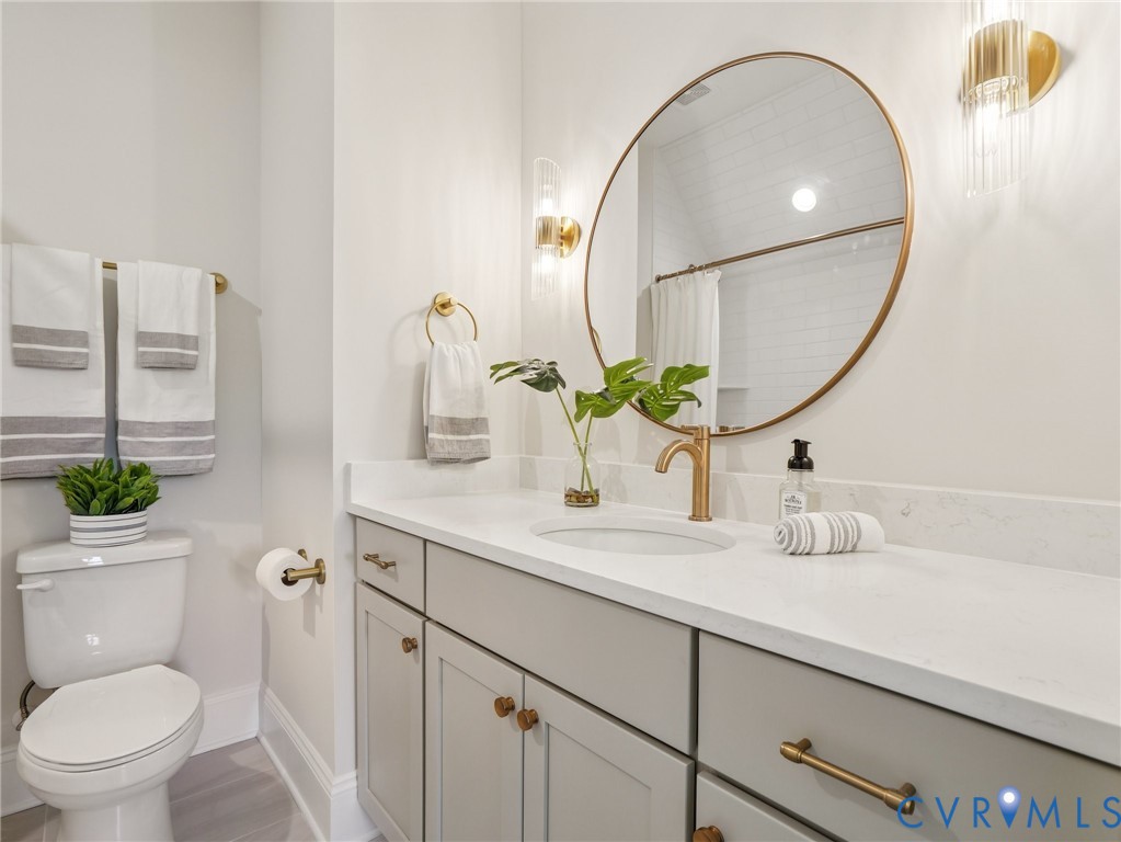 1530 Smokey Rdg Road Maidens, VA 23102 - Photo 31 of 42 a bathroom with a granite countertop toilet sink and mirror