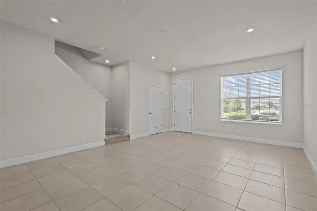 an empty room with windows and closet