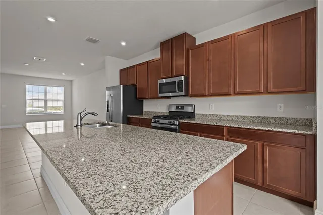 a kitchen with a stove a sink and a microwave