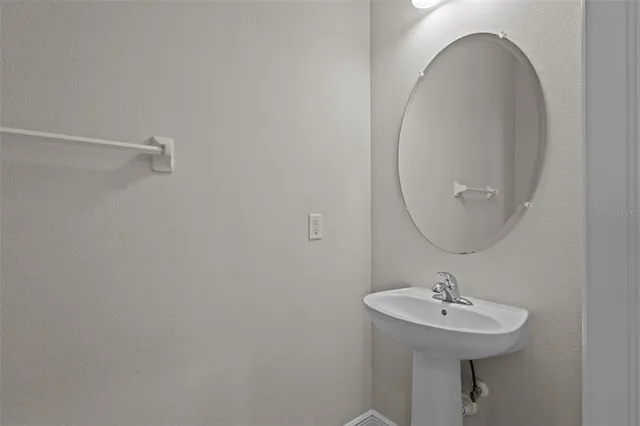 a bathroom with a sink a mirror and vanity