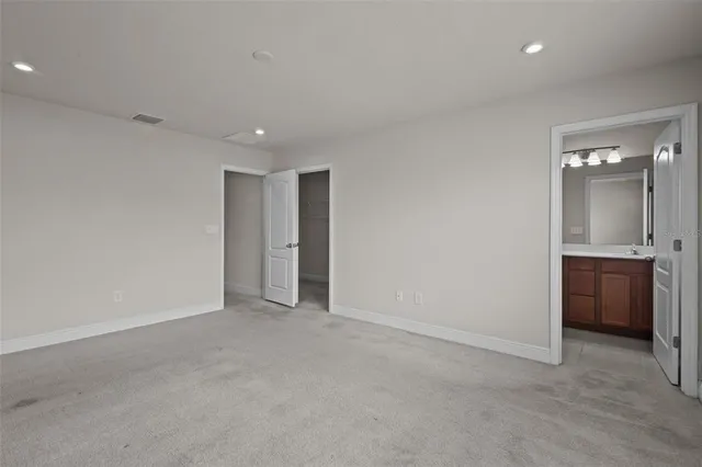 a view of an empty room with a kitchen