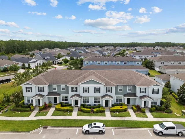 a front view of residential houses with yard and swimming pool