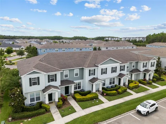 an aerial view of multiple houses with yard