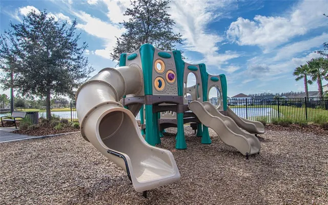 a childrens park with lots of swings and slides