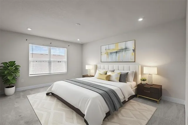 a bedroom with a bed and a potted plant