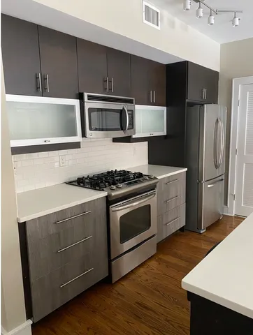 a kitchen with a stove a microwave and a refrigerator