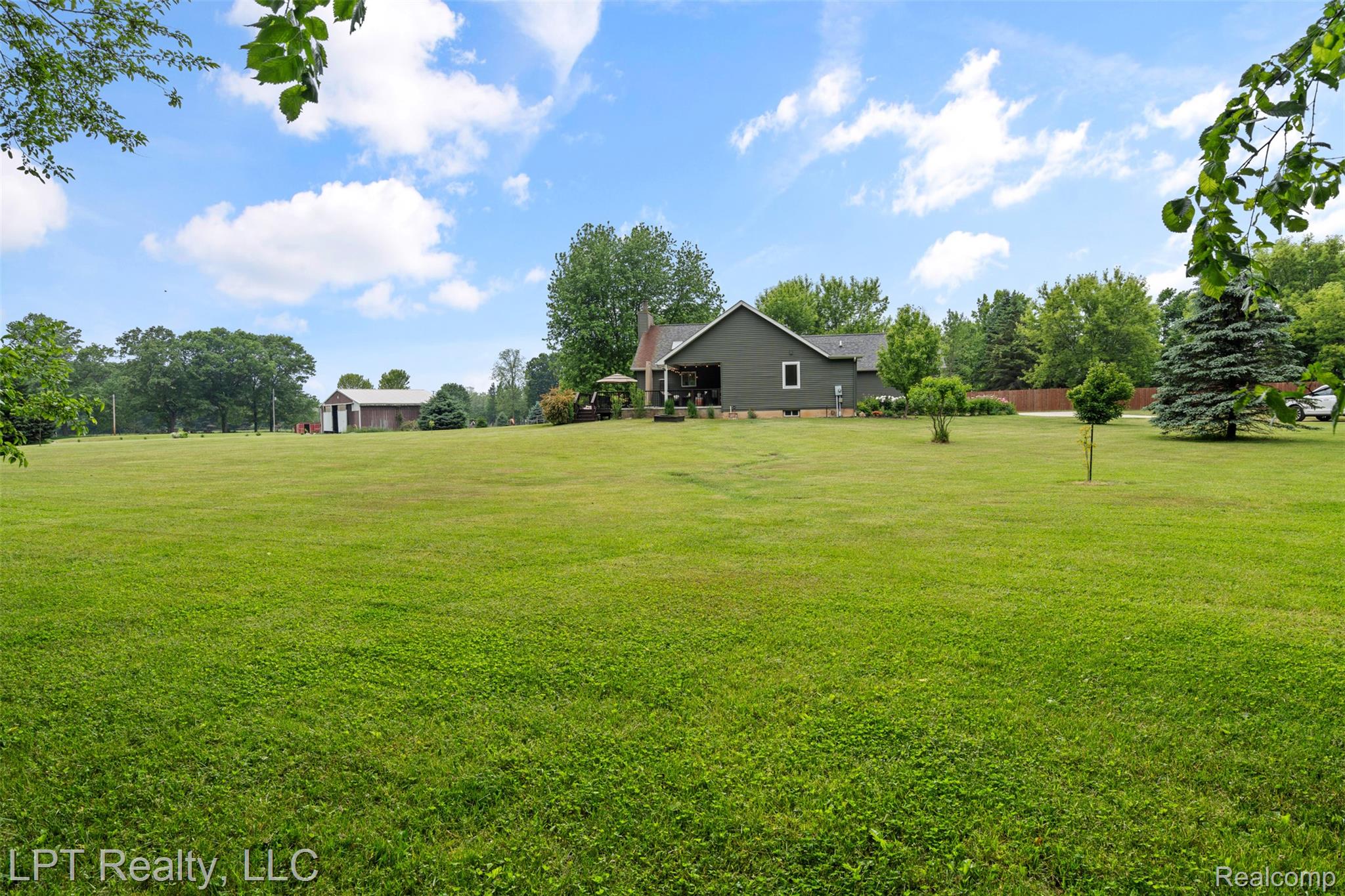 2588 East Jones Road Howell, MI 48855 - Photo 24 of 40 View of grassy yard with view of scattered trees