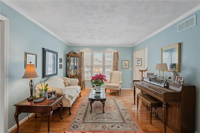 a living room with furniture and flowers