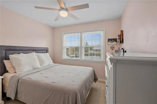 a bedroom with a large bed and a window