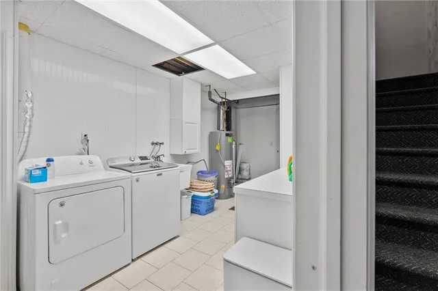 a utility room with cabinets washer and dryer