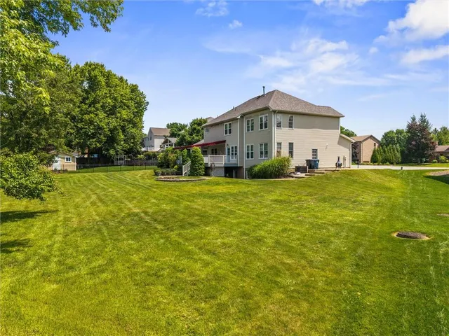 a front view of a house with swimming pool having outdoor seating