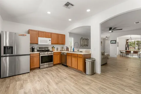a kitchen with stainless steel appliances a refrigerator and a stove top oven