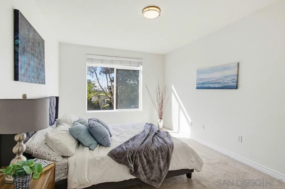 9229 Regents Road, Unit L206 La Jolla, CA 92037 - Photo 11 of 29 a bedroom with a bed and a window