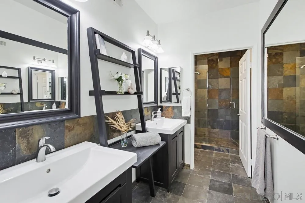 9229 Regents Road, Unit L206 La Jolla, CA 92037 - Photo 13 of 29 a bathroom with a sink and a mirror
