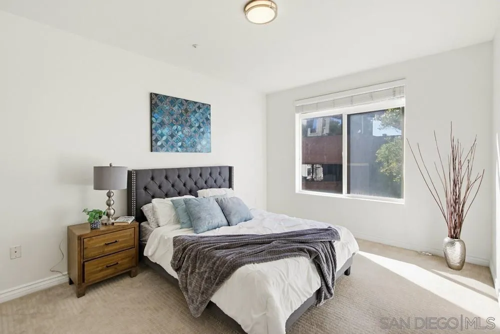 9229 Regents Road, Unit L206 La Jolla, CA 92037 - Photo 10 of 29 a bedroom with bed and a window