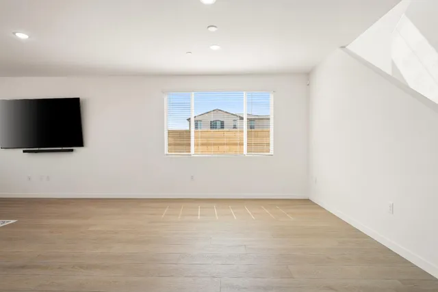 a view of kitchen with refrigerator and window
