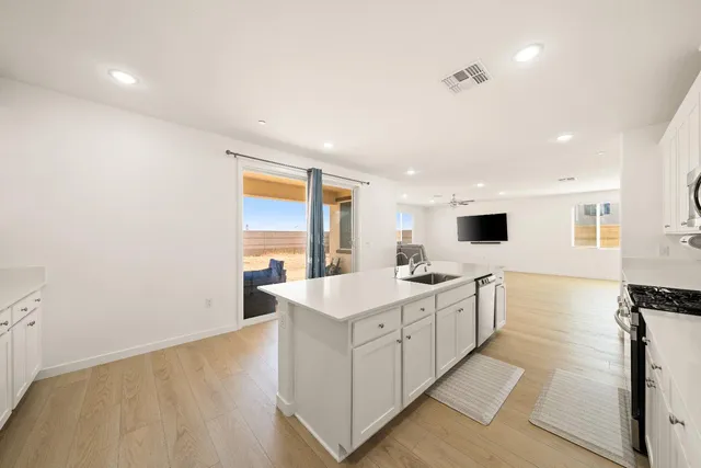 a kitchen with a sink a stove and cabinets