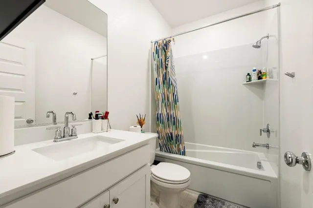 a bedroom with a bed window and a desk