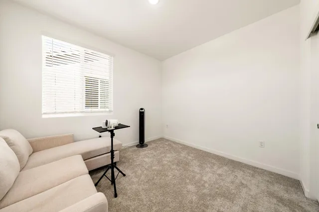 a living room with furniture a air conditioner and a window