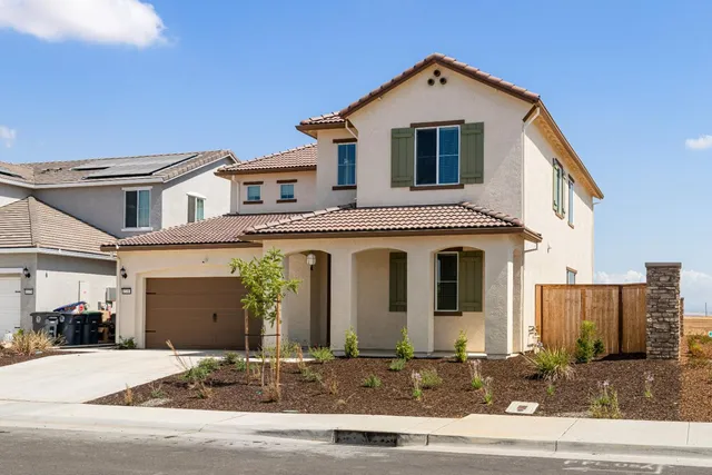 a front view of a house with garage