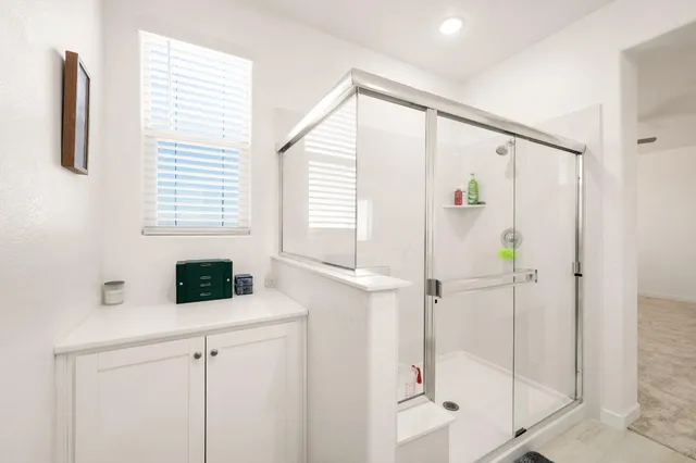 a view of walk in closet with clothes