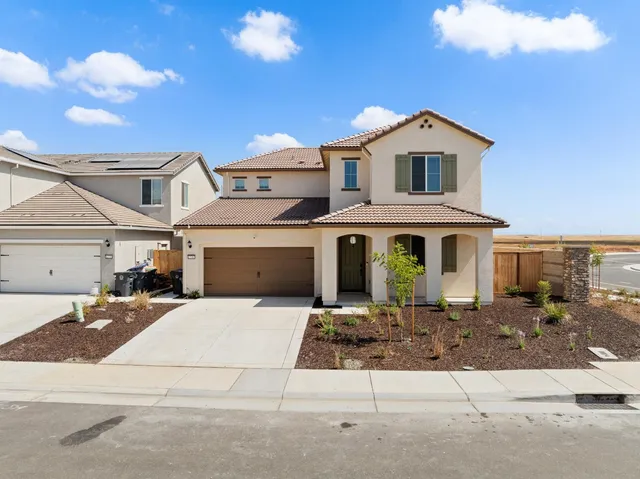 an aerial view of residential houses with an ocean
