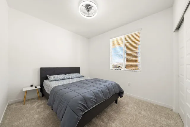 a bedroom with a bed and a window