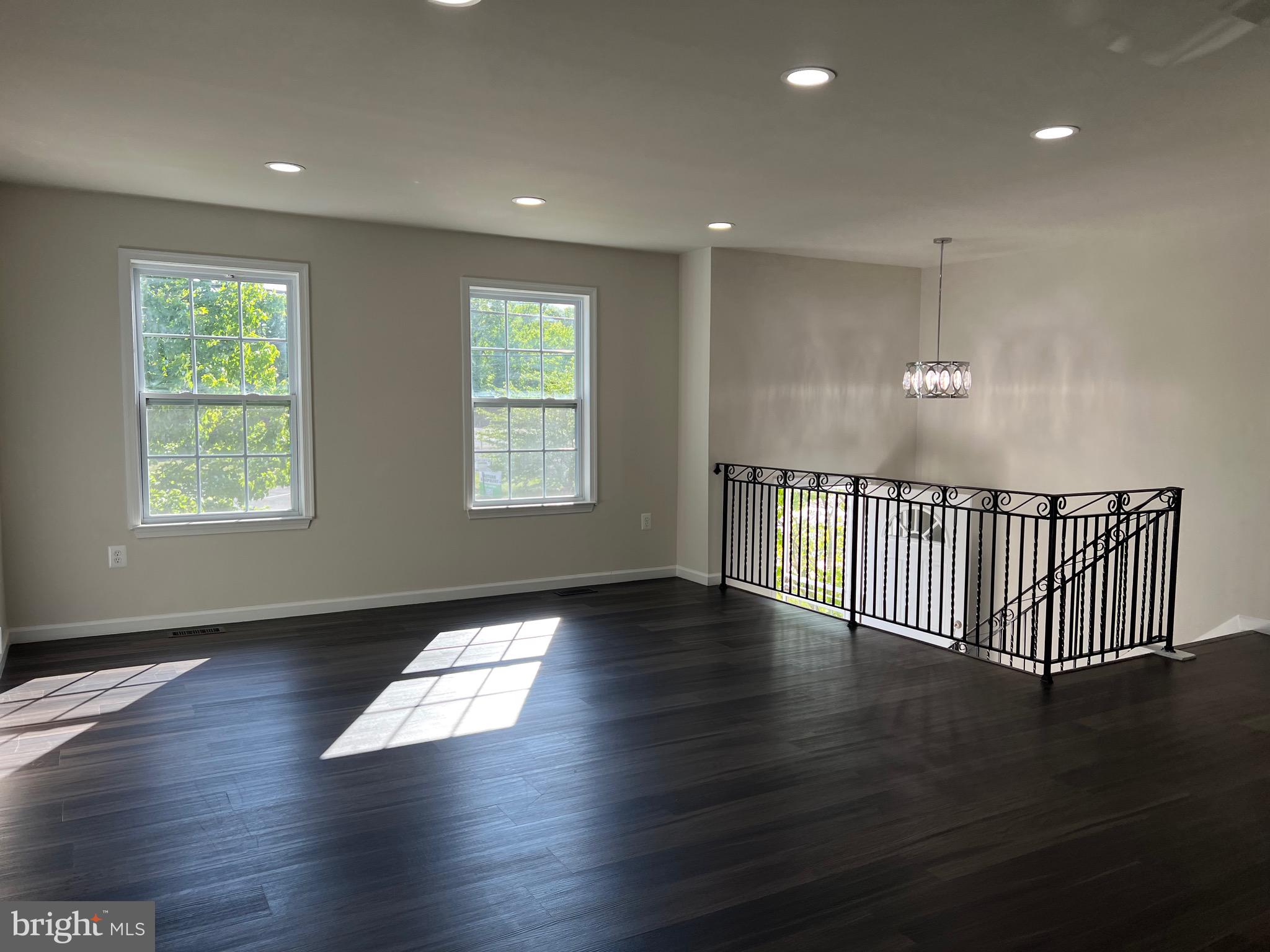 6604 Suitland Road Suitland, MD 20746 - Photo 8 of 27 an empty room with wooden floor and windows