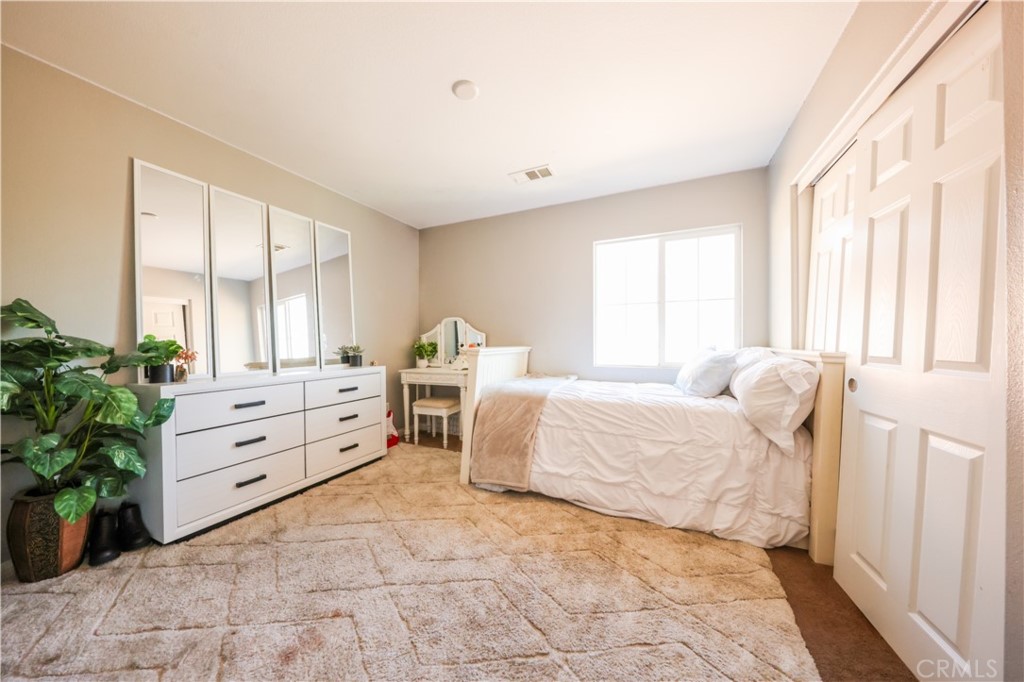 3848 Vine Maple Road San Bernardino, CA 92407 - Photo 13 of 25 a bedroom with a bed and a large window