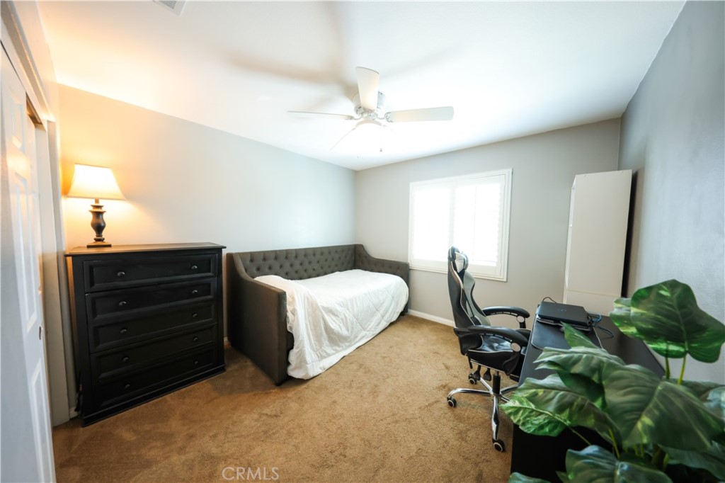 3848 Vine Maple Road San Bernardino, CA 92407 - Photo 15 of 25 a bed room with a bed window and a chair