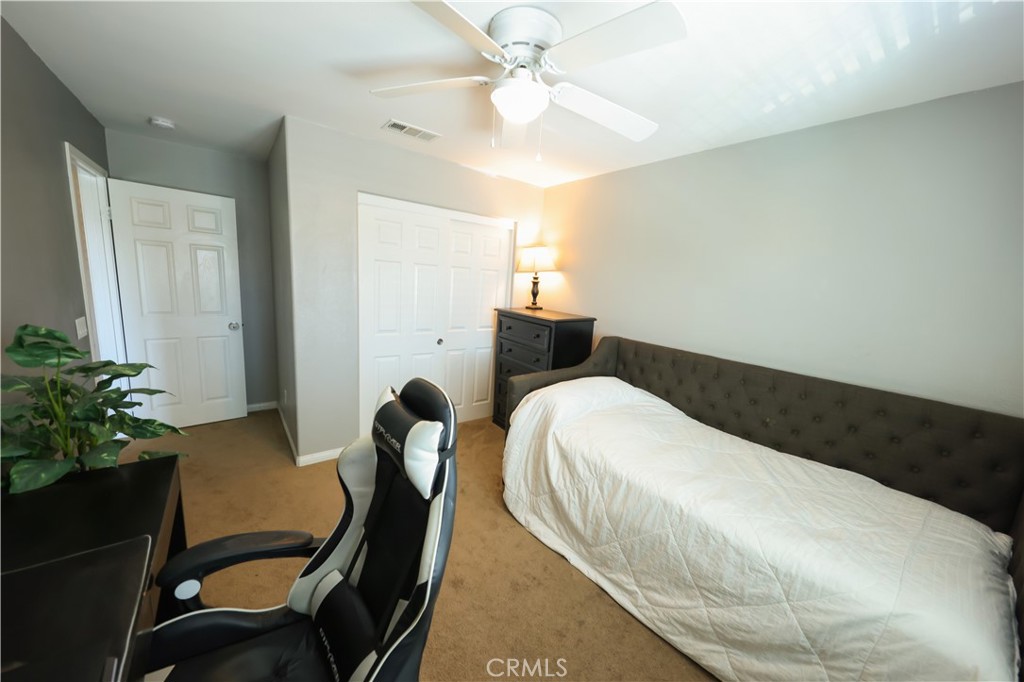 3848 Vine Maple Road San Bernardino, CA 92407 - Photo 16 of 25 a bedroom with a bed and a chair