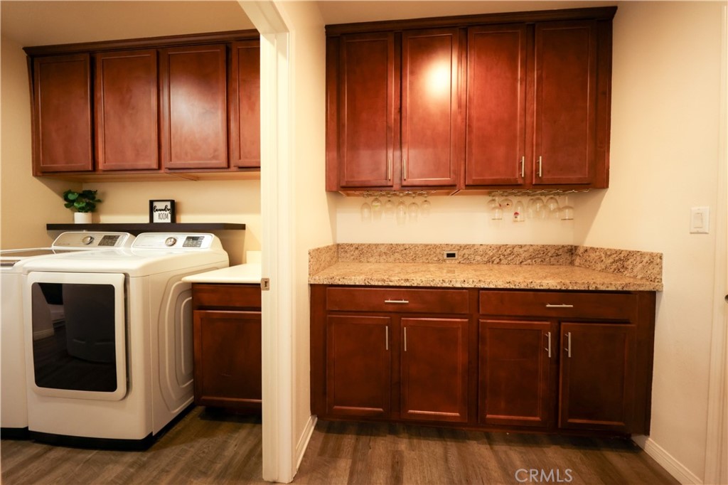 3848 Vine Maple Road San Bernardino, CA 92407 - Photo 20 of 25 a view of a kitchen with wooden floor and cabinets