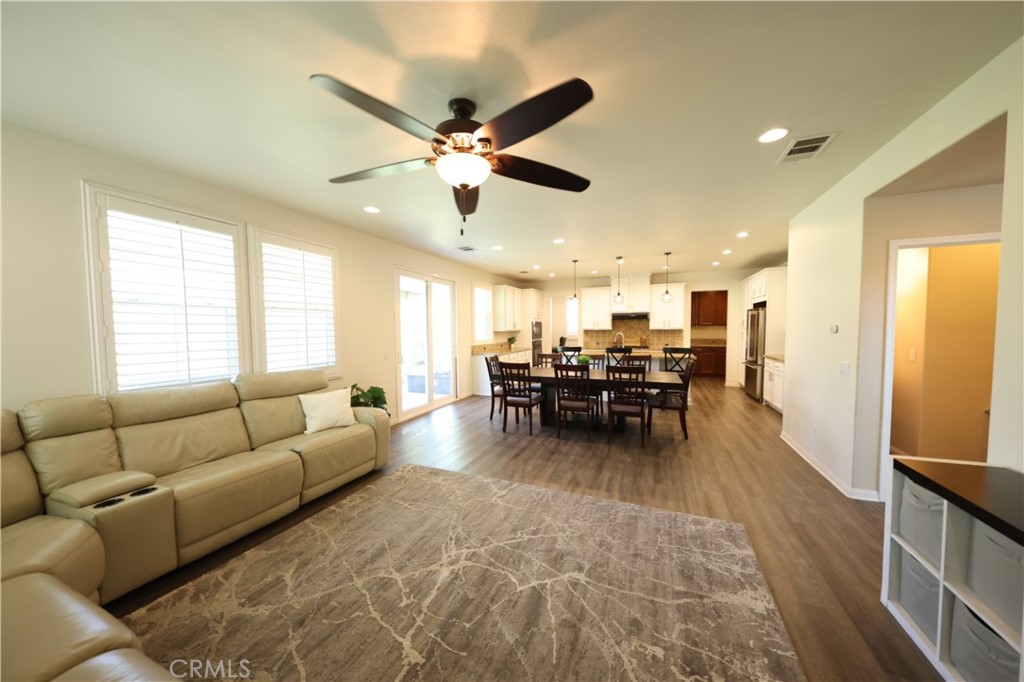 3848 Vine Maple Road San Bernardino, CA 92407 - Photo 9 of 25 a living room with furniture and kitchen view
