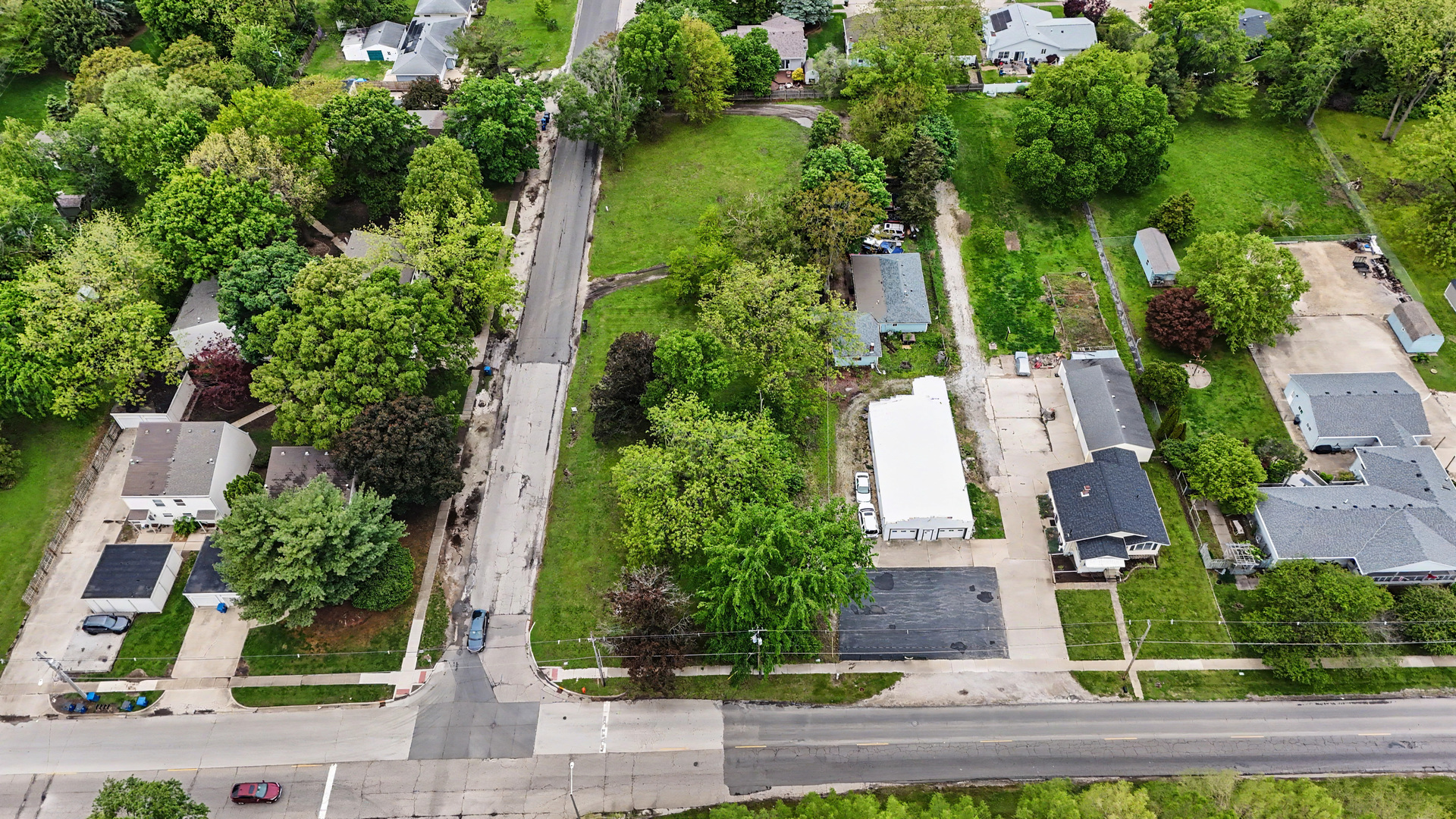 2404 West John Street Champaign, IL 61821 - Photo 16 of 24 an aerial view of a house with a yard and lake view