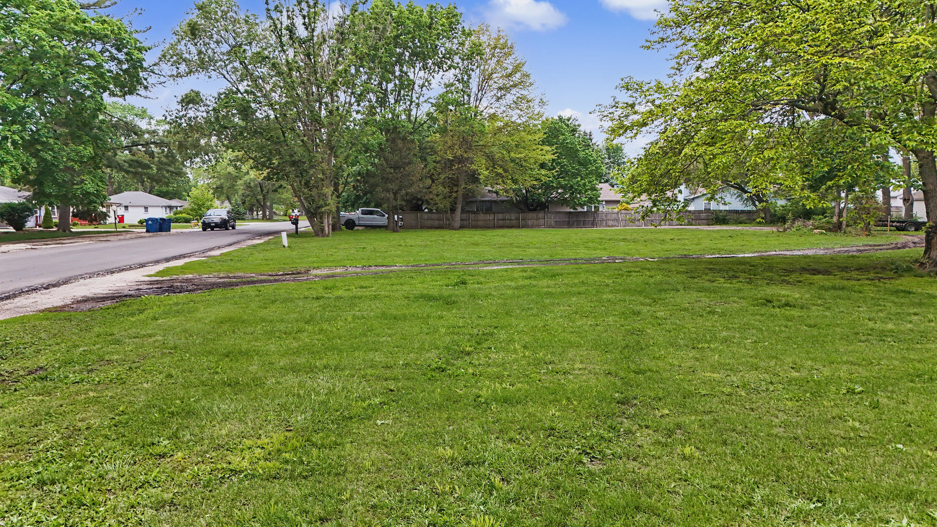 2404 West John Street Champaign, IL 61821 - Photo 22 of 24 a view of yard with trees and cars
