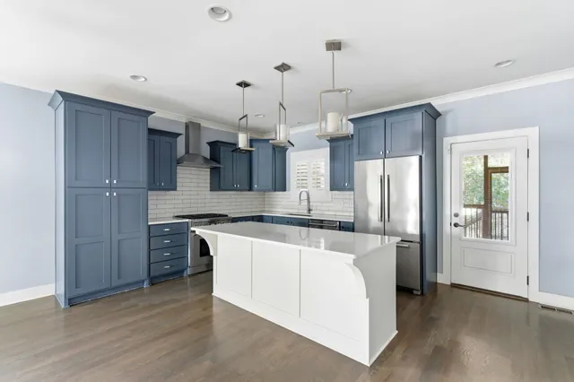 a kitchen with granite countertop cabinets and stove top oven
