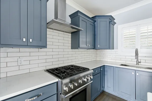 a kitchen with stainless steel appliances a refrigerator sink and cabinets
