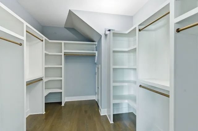 a view of walk in closet with empty racks