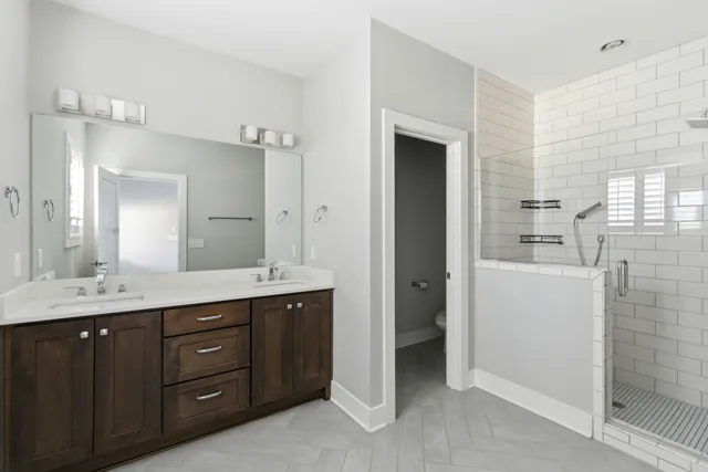 a bathroom with a sink a toilet and a mirror