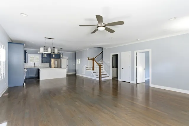 a view of a kitchen with wooden floor and a window