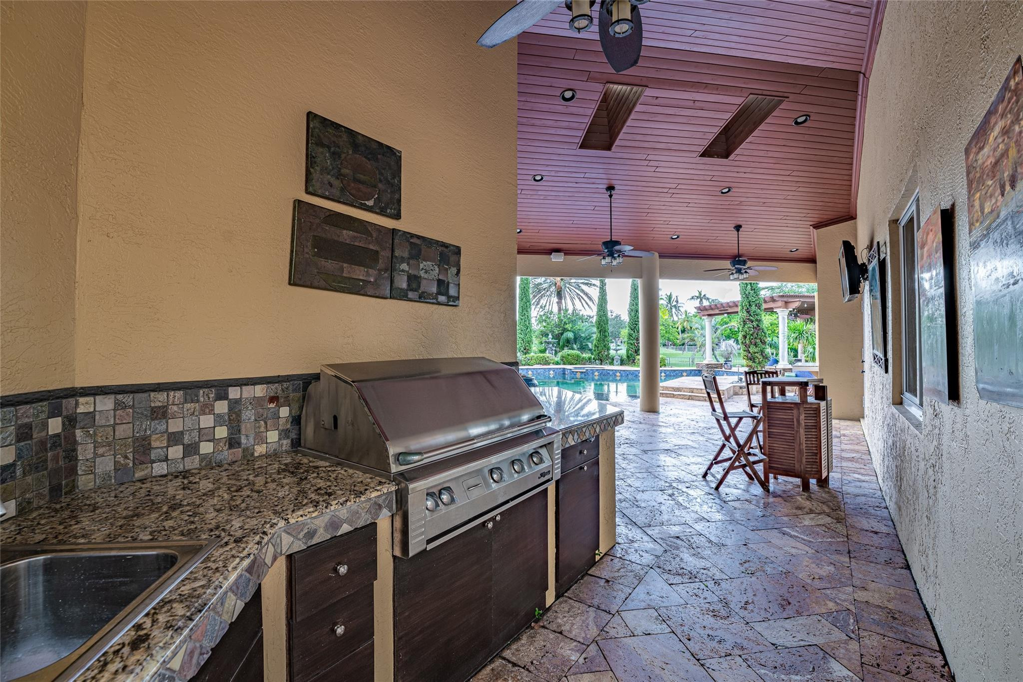3220 Paddock Road Weston, FL 33331 - Photo 28 of 59 a kitchen with a stove and a sink