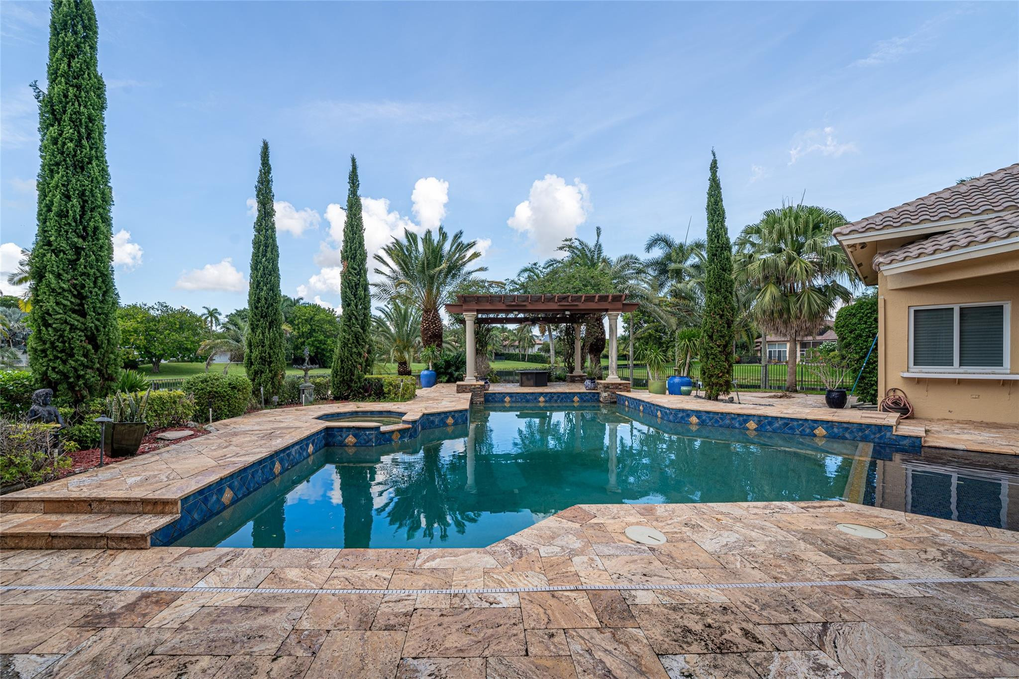 3220 Paddock Road Weston, FL 33331 - Photo 31 of 59 a view of a swimming pool with a lounge chairs