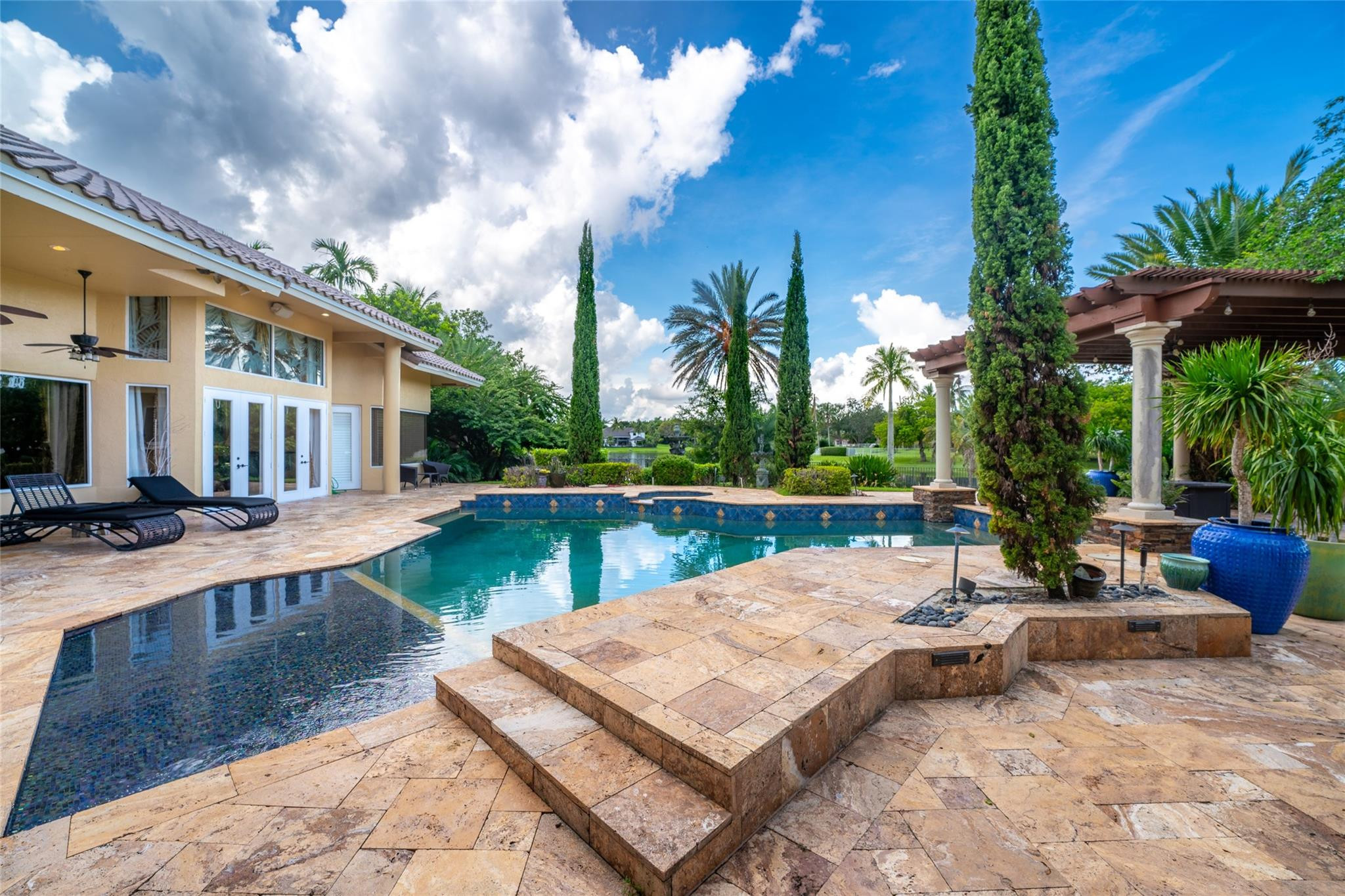 3220 Paddock Road Weston, FL 33331 - Photo 32 of 59 a view of a house with backyard patio and swimming pool