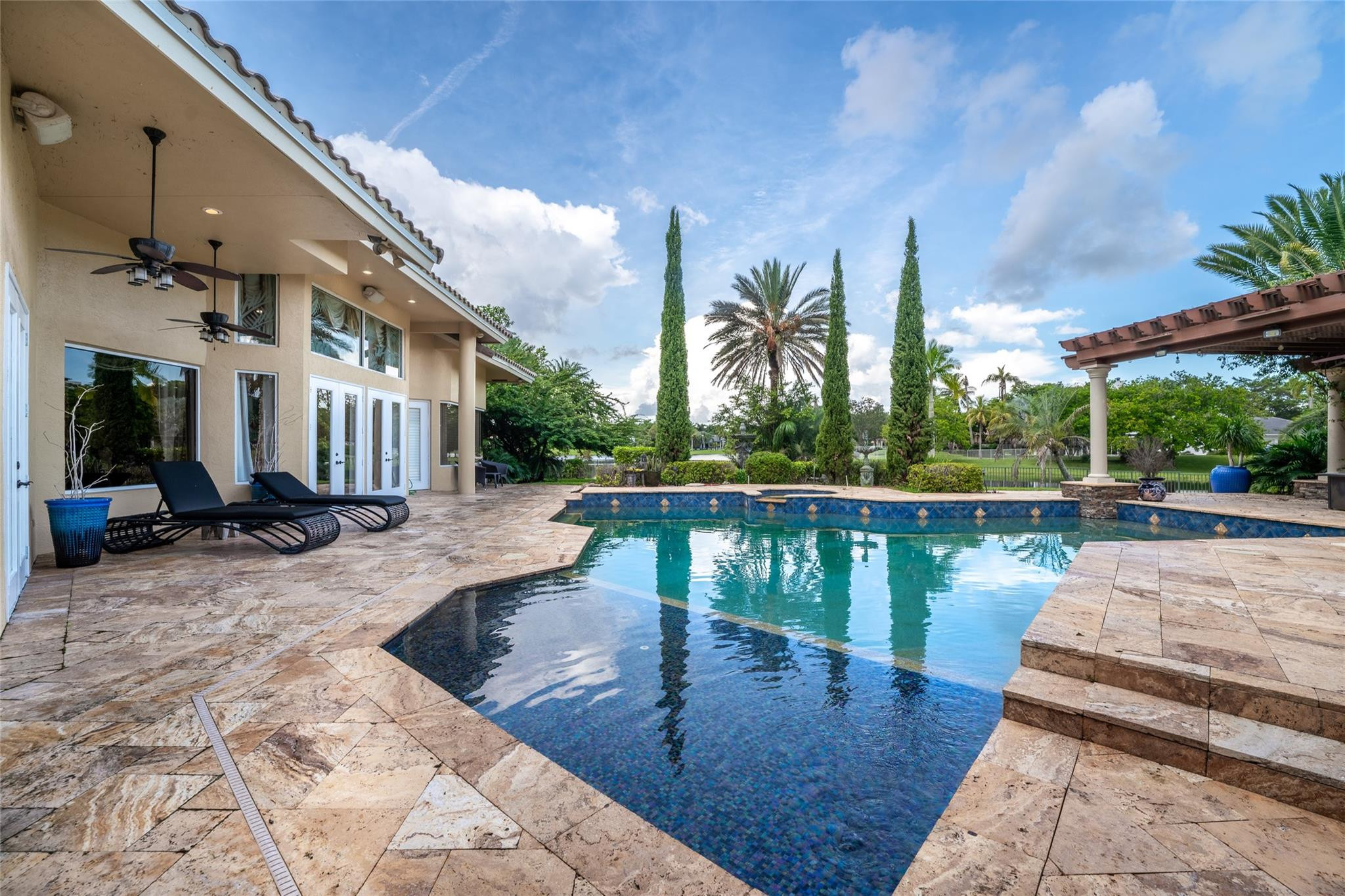 3220 Paddock Road Weston, FL 33331 - Photo 34 of 59 a view of a swimming pool with a patio