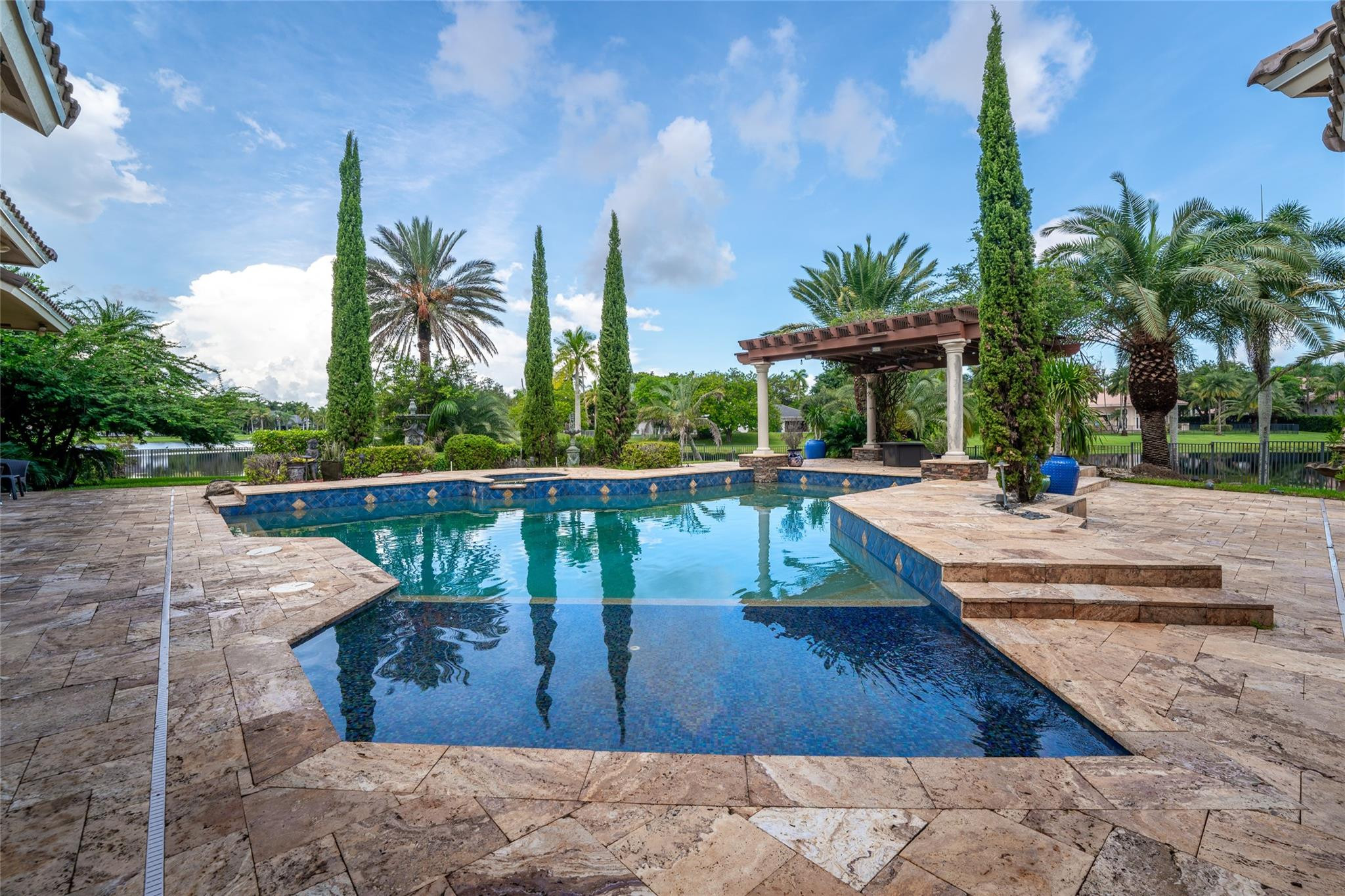 3220 Paddock Road Weston, FL 33331 - Photo 35 of 59 a view of a swimming pool with a patio