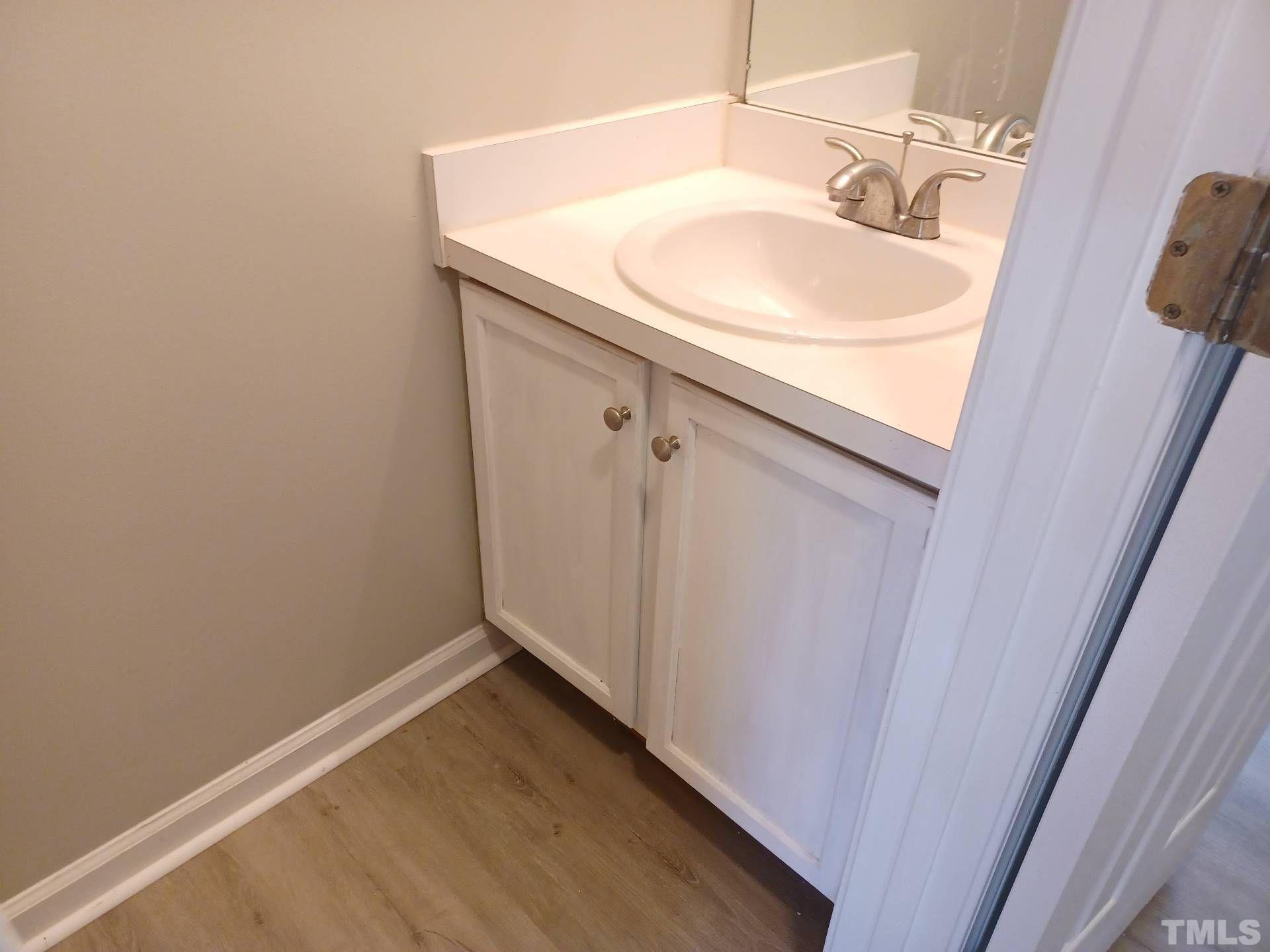 208 Lindell Drive Apex, NC 27539 - Photo 11 of 27 a bathroom with a sink and a mirror