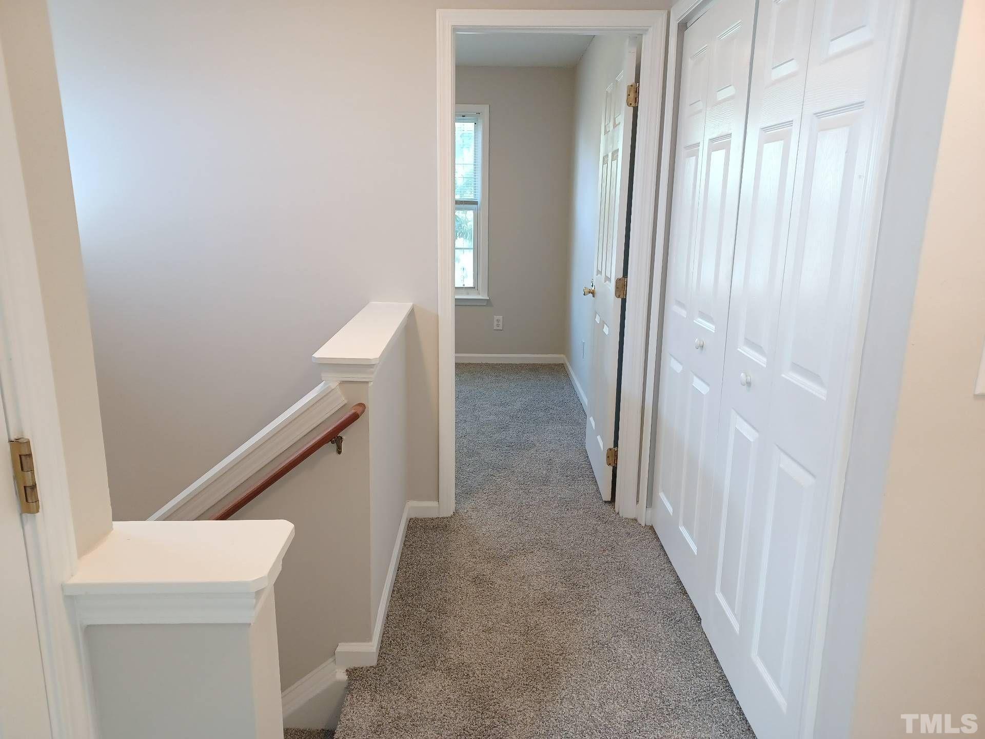 208 Lindell Drive Apex, NC 27539 - Photo 13 of 27 a view of a hallway with washer and dryer